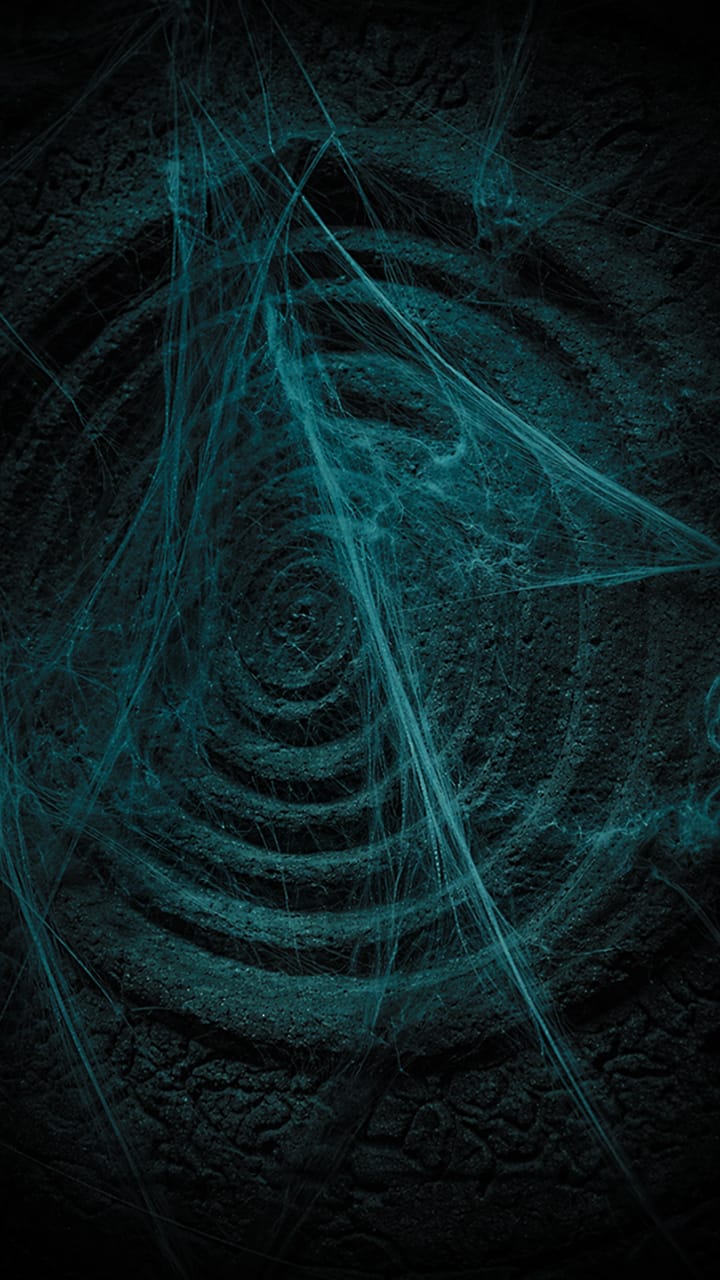 Spiral stone carving with glowing cobwebs